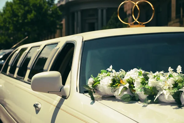 depositphotos_105414378-stock-photo-white-wedding-limousine-decorated-with